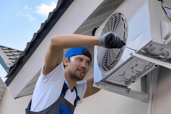 technician installing air conditioning services