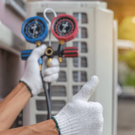 Technician performing seasonal HVAC maintenance on an outdoor unit beside a Florida home