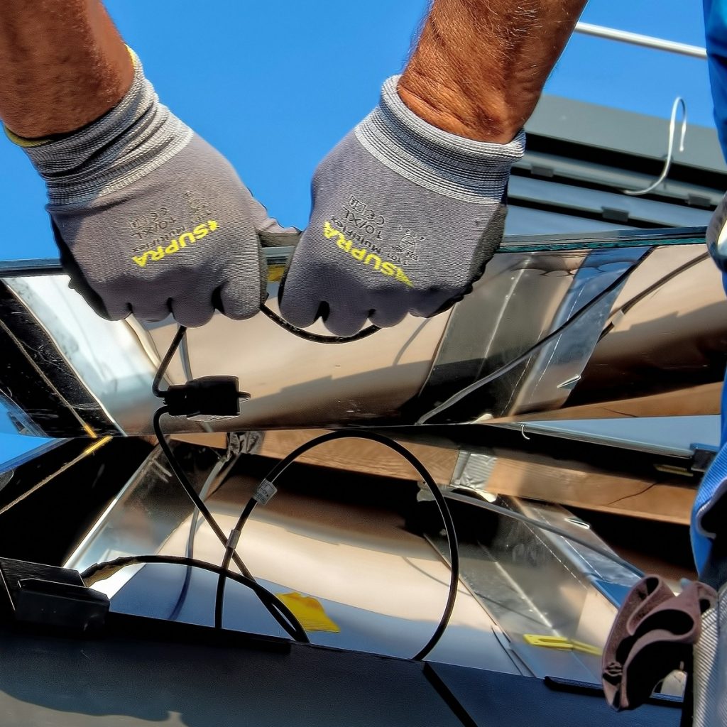 An installer shaping and joining sheet-metal air ducts to improve airflow through the home during professional Ductwork and Ventilation Services in Panama City Beach, FL.