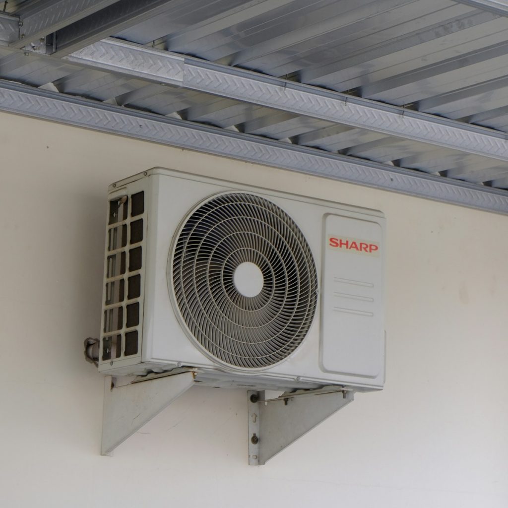 A newly replaced outdoor AC condenser set on a tidy pad, showing the quality homeowners get from Heating and HVAC System Services near me.